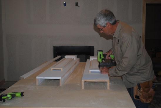 For the capitals, he installs smaller U-shaped pieces above the reeded sections.