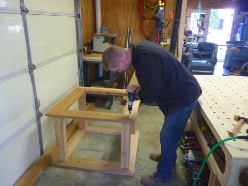 The top frame for the louvered section secures to the posts with long screws.