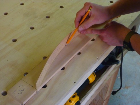 To scribe the arch for the frieze board, author uses a batten made from a thin rip of wood.