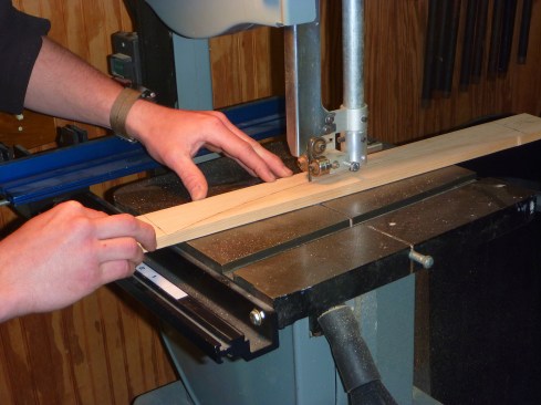 A band saw cuts the arch in each frieze board, and after smoothing the edge a chamfer is added along the outer face. 