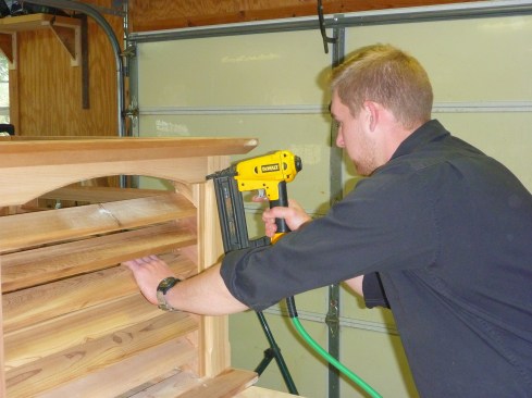 The arched frieze nails in at the top of each louvered side. 