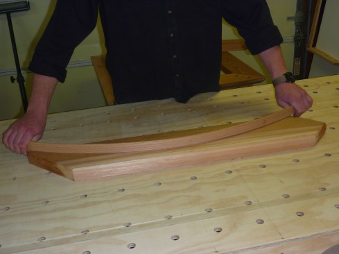 To create the swooped roof, the author uses a thin batten to scribe the curve to each of the rafters.