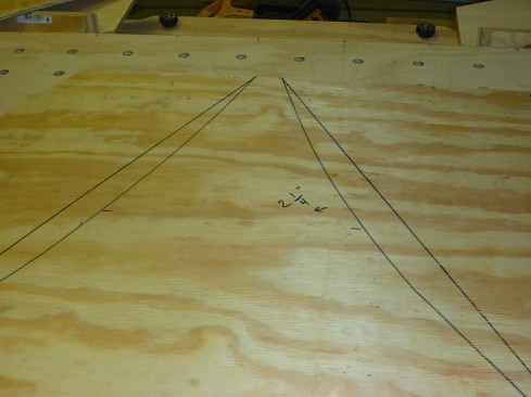 For the curved roof planes, author laid out triangular pieces of sheathing with curved edges.