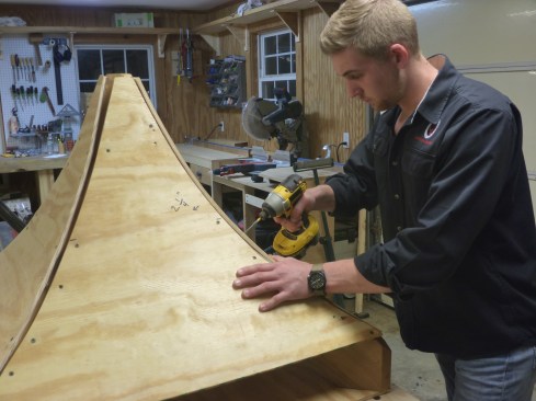 The sheathing screws to the rafters to create the swooped roof planes.