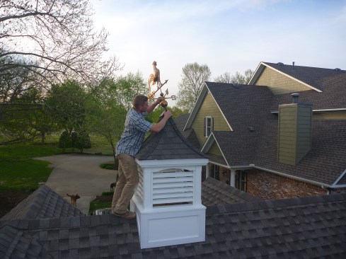 A weathervane tops off the cupola, with its base weather-sealing the peak of the cupola roof.