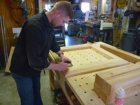 Layout lines at the corners of the frame guide the placement of the corner posts.