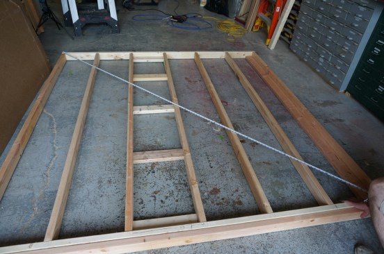 Next square the wall by taking diagonal measurements. Once the wall is square, secure it before adding the sheathing.