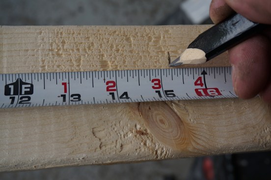With the plates stacked together on edge pull the measurement from one end. To put the studs centered on the 16-inch layout mark, mark 3/4 inch (half the thickness of 2x stock) to one side of the mark.