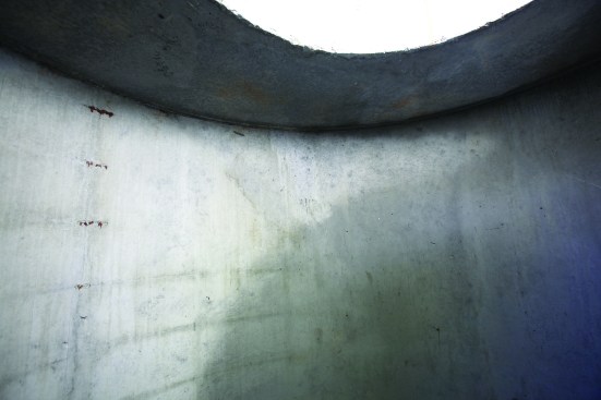 A 6-foot-tall-by-60-inch-diameter precast concrete pipe makes up the walls of the pit, and a reinforced concrete manhole ring was cemented to the top of the pipe.