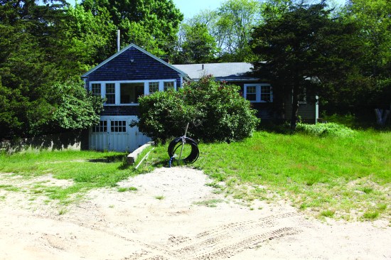A second water line remains coiled above ground, awaiting the renovation of a nearby guest cottage on the property.