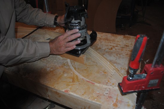 A block attached to the table of the router keeps the router flat and perpendicular to the molding stock. 