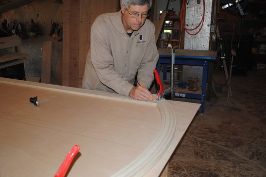 The author then scribes the tops of the stiles to the curve of the top rail.