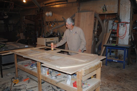 The author applies a bead of glue to the back of the frame before setting the plywood in place.