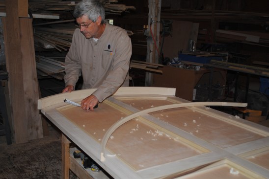 Before building the curved top, the author measures up and lays out precisely where the top will fit against the back panel.