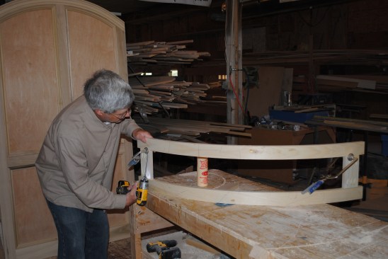 Pocket screws and glue join the stiles to the curved rails. The center stile is left off intentionally at this point.