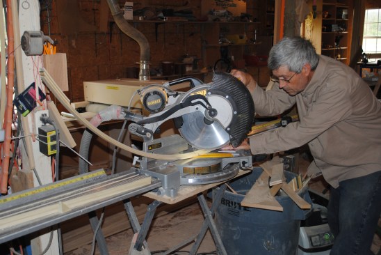 Cutting the curved panel molding requires the position of the cut to be perfectlyflat on the saw table while the ends curve up.