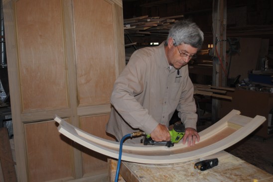 The curved molding sections glue and nail into place.