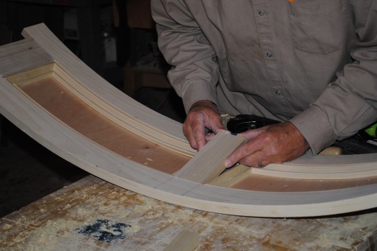 Finally the author cuts the center stile and slips it into place. Because the sides of the stile are straight, it's much easier to adjust the fit of this piece, rather than fussing with the fit of the panel molding.