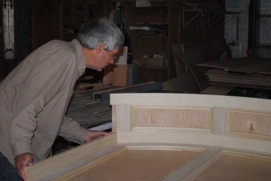 The author sets the stiles for one of the side panels on the layout lines drawn earlier and marks the angle where the piece intersects with the top.