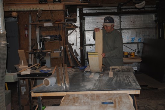 Author carefully runs the curved lamination through a table saw to clean up the edges.