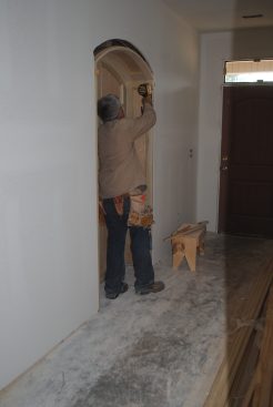 Installing the niche is much like putting in a pre-hung door. The author begins by attaching a top corner.