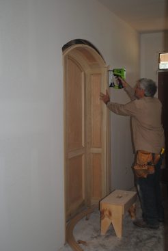After attaching the niche to the framing on both sides of the opening, the author nails on the jamb casing. 