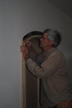 Before attaching the head casing, the author slips dominoes into the slots along with glue.