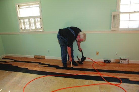The next step in the dance is tapping the strip snuggly against the installed flooring.