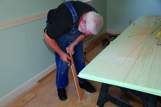 The quickest and most accurate way to cut to the scribe line is with a hand plane. The angled cut from the saw makes this a quick operation.