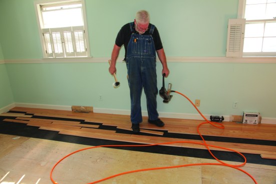 An installer's feet get as much of a workout as the arms. Soft-soled shoes are a must! The first step is pulling the next board over from the "rack."