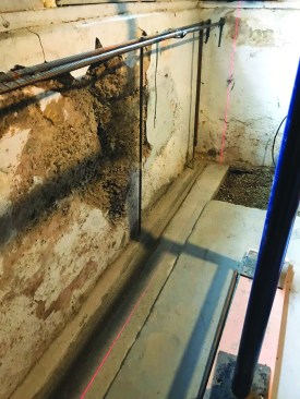 A keyway cast into the footing helped to lock the bench wall in place, while a laser line was used to guide placement of the form.