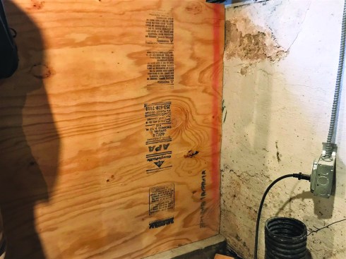 After scribing the form plywood to the adjacent wall, the crew built a frame for the form.