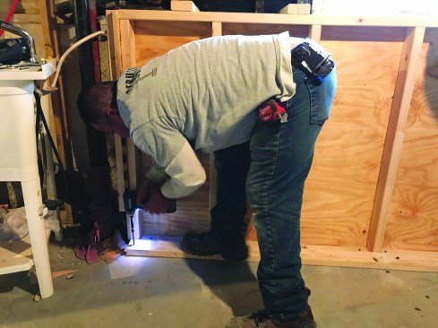 A 2x4 anchored to the slab held the bottom of the form in place.