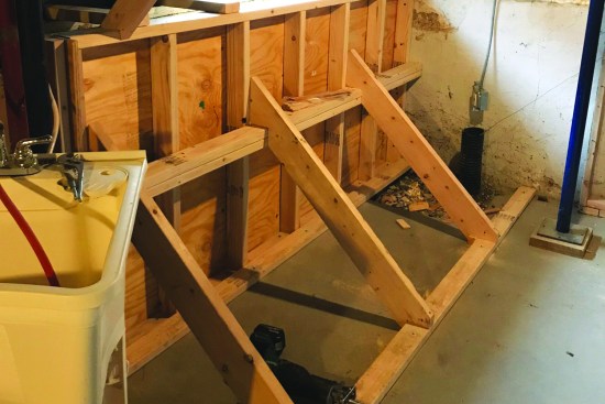 To ensure that the form didn’t move or bow out during the pour, the crew attached a horizontal strongback across the middle. Diagonal 2-bys braced back to the floor provided additional support.
