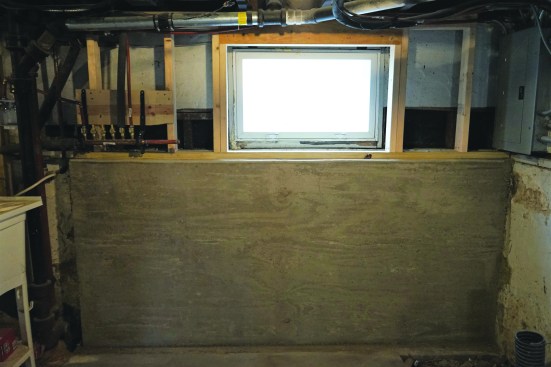 After placing the concrete and allowing it to set for a few days, the crew stripped the form and framed a 2x4 wall tight between the bench wall and the joists above. In addition to the wall helping support the floor and exterior wall loads, pressure on the wall added to the lateral stability of the bench wall.