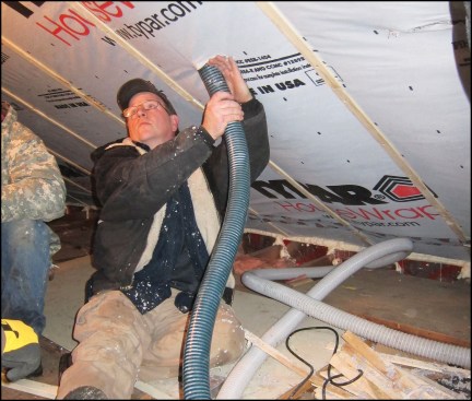 In existing construction, weatherizers typically dense-pack cellulose behind strapped housewrap.