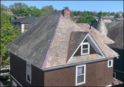 A view of the north- and west-facing sections of the restored roof. In the end, roughly 75% of the existing slates were left intact.