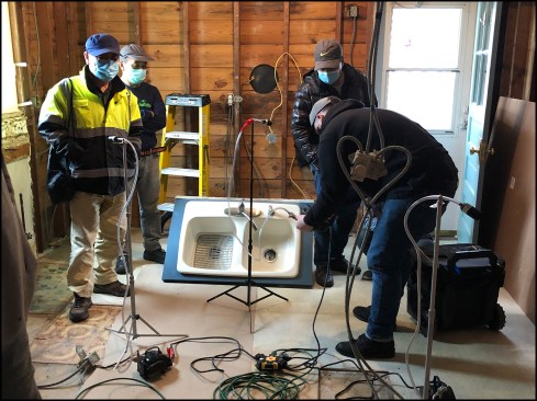 A third-party air monitoring firm sets up equipment to take a baseline air test.