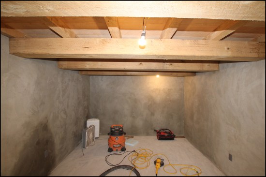 The wine-room walls are finished with a three-coat stucco finish. The rough-sawn timber beams and planking give the wine room’s ceiling a vintage, Old European look.