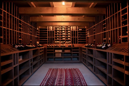 Designed by the architect-client, the wine shelving was built by NDC crew members using walnut-veneer plywood with walnut face frames.