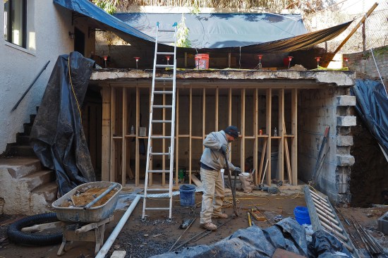 A crew member bends rebar as he prepped for the installation the liner wall’s robust reinforcing grid.