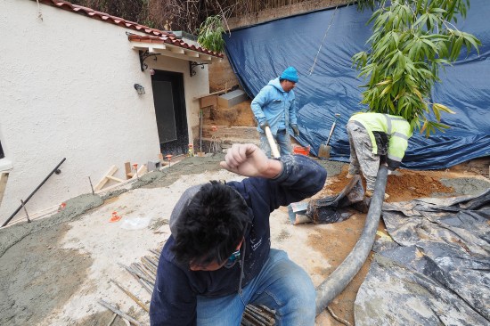 As the foundation crew poured the walls, they wet-set rebar dowels are into the access holes (the dowels help tie the existing concrete slab to the new liner walls).