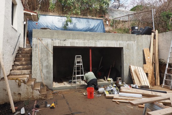The new wall was poured with a squared-up opening. (The new door’s arch-top rough openings were later framed out with 2-by stock with a stucco finish).