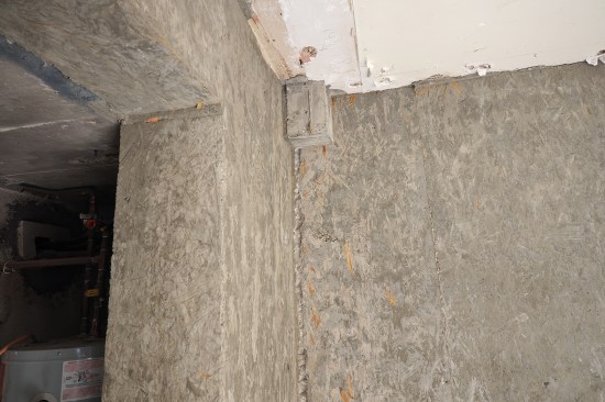 For the stairs to work correctly at the upper patio, a new landing was poured, shown here above the small mechanical space under the stairs. (The existing slab was cut away to fit in the additional riser.)