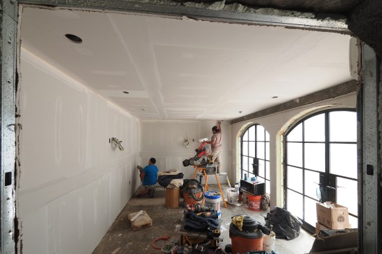 The masonry walls and ceiling were furred out with steel studs to run wiring and lighting, while the front wall was framed out with 2-by stock to more easily frame the rough openings for the arch-top doors.