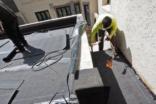 The membrane was run up and over the parapets, as well as down the stair flight.