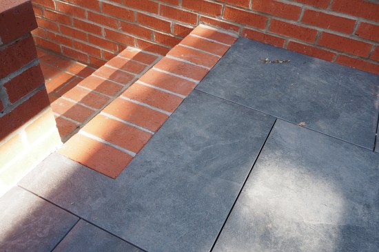 New ceramic tile pavers planed into reconfigured brick stairs.