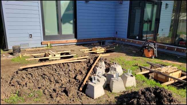 Figure 1A. In front of the southwest-facing kitchen, the pergola footings are laid out in a L-shape pattern.