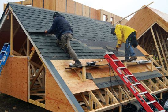 The first course of shingles was nailed at the top so we could slip the last course from the next layout group under it before nailing off that course. We repeated the process until we were within a course of the opening at the eaves.