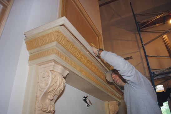 After a layer of decorative crown is applied, the top of the mantel shelf slides into place as the top layer.